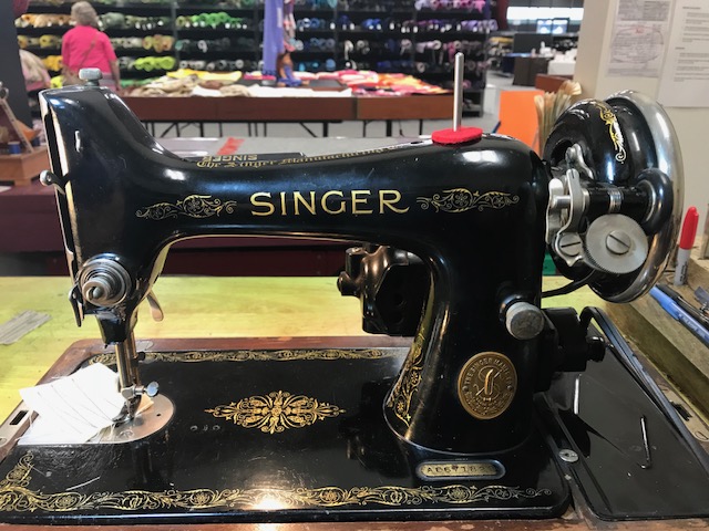 Vintage Singer sewing machine photographed from the side.