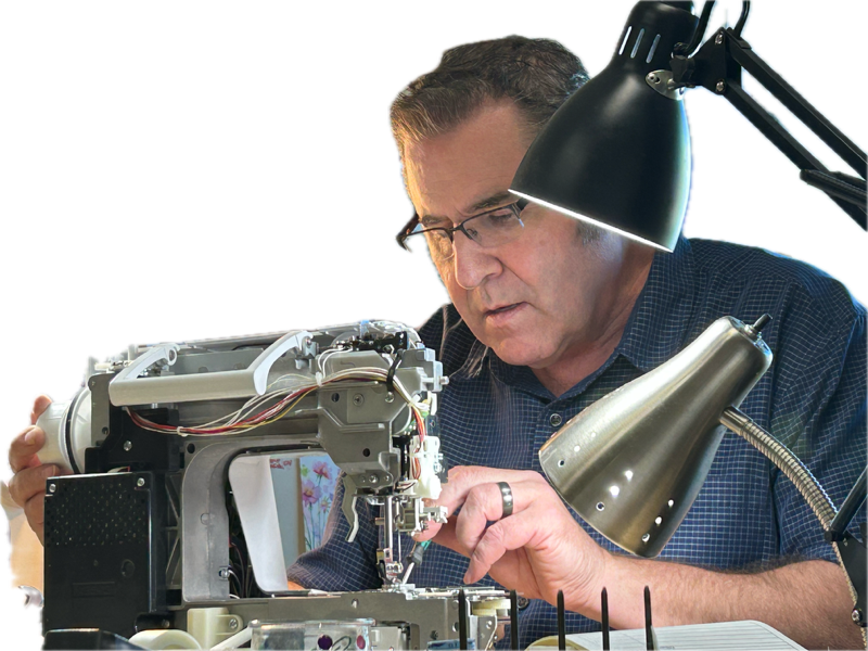 Steve Kraft working on an open sewing machine at his repair bench.
