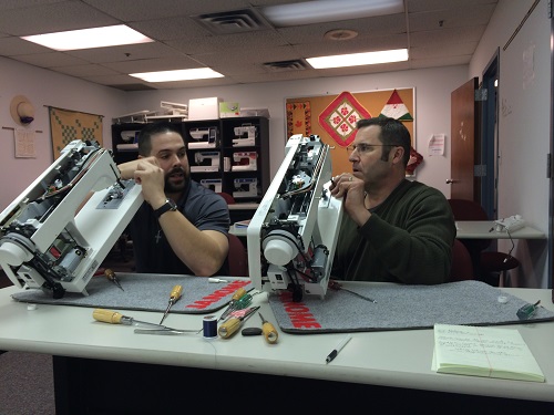 Steve Kraft working beside sewing machines on the repair bench.